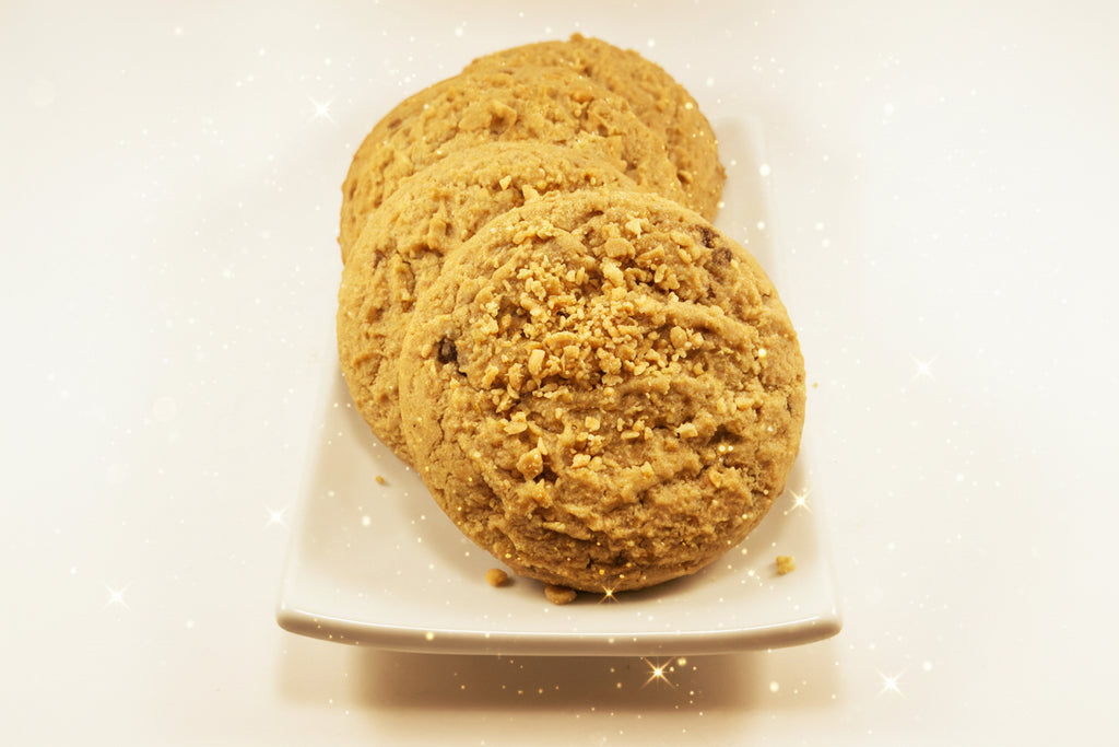 Four Peanut Butter Cookies on a white plate spangled with stars. 